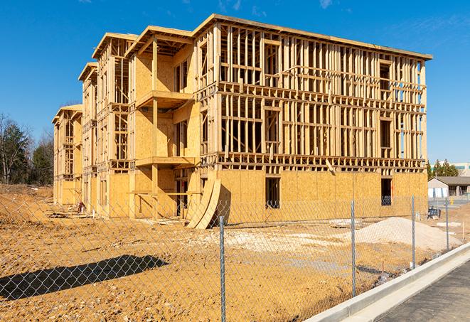 a temporary chain link fence winding around a job site, outlining the project's progress in Richmond, TX